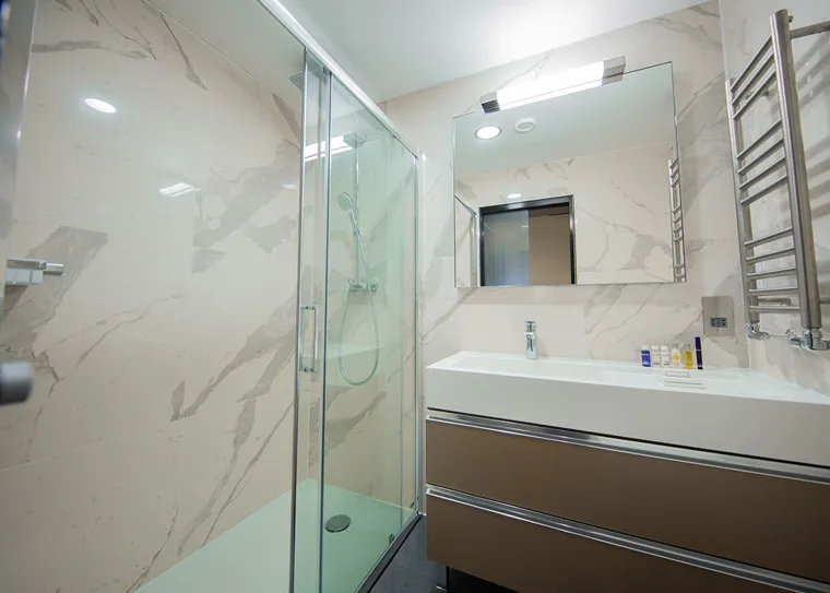 Glass shower enclosure and tiled bathroom