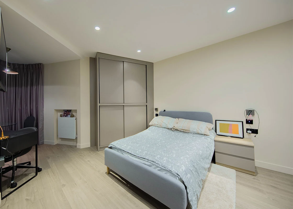 Bright furnished studio with a double bed, fitted wardrobe and study space